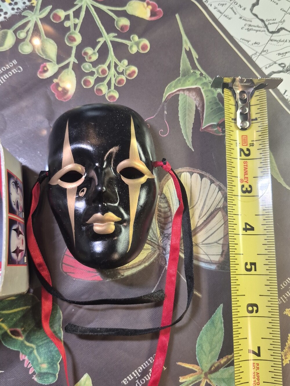 Black and Gold Decorative Venetian-Style Mask with Red & Black Ribbons